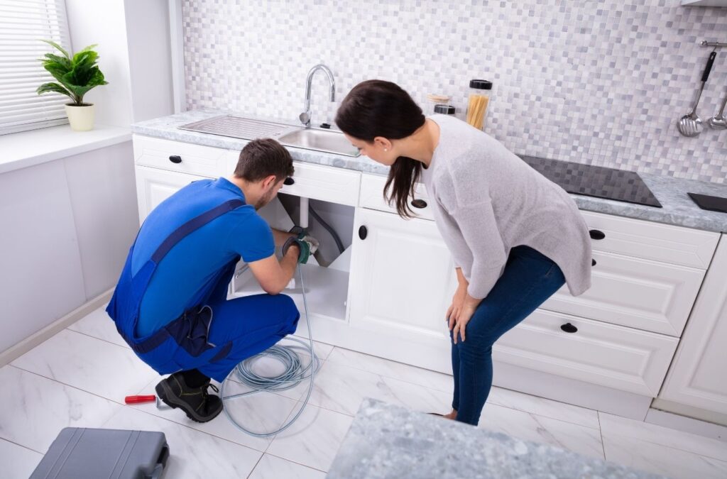 Saving Plumbing technician completing plumber service in East York, ON using specialized plumbing tools to repair pipes and maintain efficient plumbing systems.
