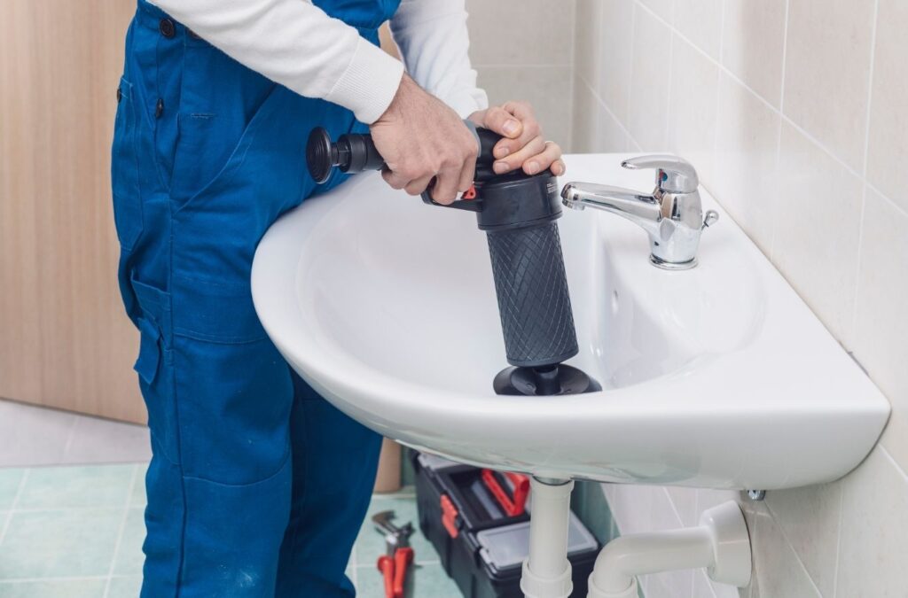 Saving Plumbing technician performing plumber service in Ajax, ON repairing pipes and plumbing fixtures using professional equipment for reliable plumbing systems.